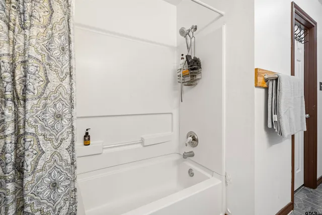 a bathroom with a bathtub and shower