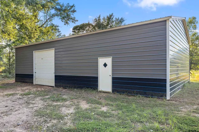a view of a house with a yard and garage
