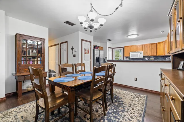 a view of a dining room with furniture and chandelier