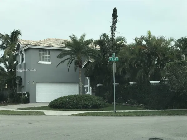 a house that has a tree in front of it