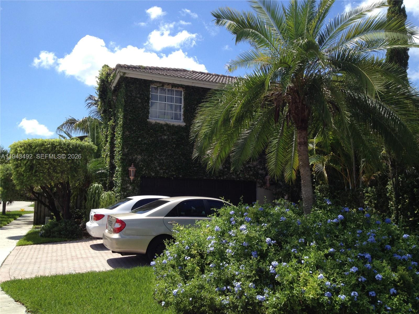 15448 Southwest 92nd Street Miami, FL 33196 - Photo 18 of 36 a garden with palm trees