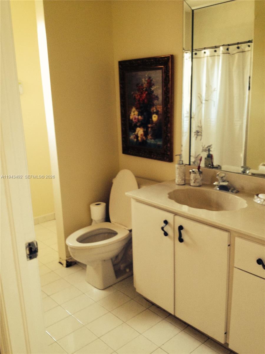 15448 Southwest 92nd Street Miami, FL 33196 - Photo 20 of 36 a bathroom with a sink mirror vanity and toilet