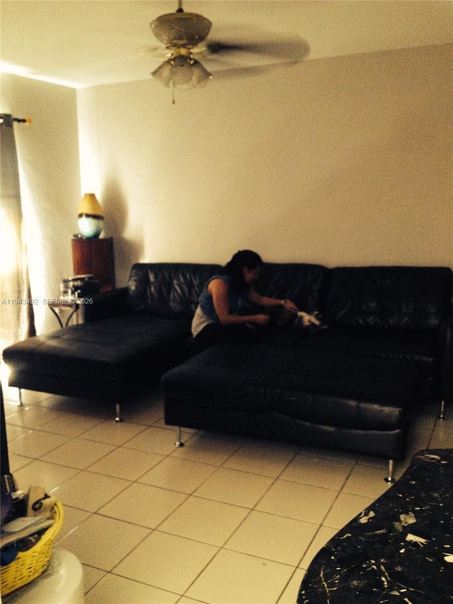 15448 Southwest 92nd Street Miami, FL 33196 - Photo 21 of 36 a living room with a couch and a potted plant