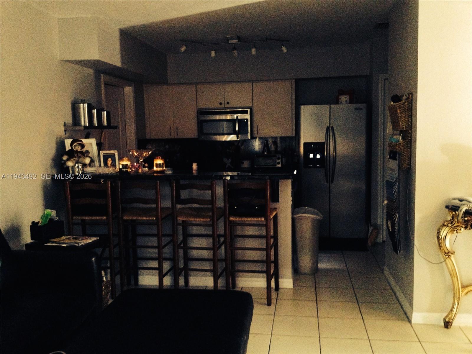 15448 Southwest 92nd Street Miami, FL 33196 - Photo 22 of 36 a kitchen with refrigerator and cabinets
