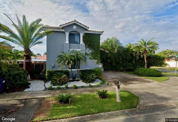 15448 Southwest 92nd Street Miami, FL 33196 - Photo 3 of 36 a front view of a house with garden