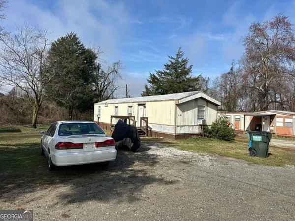 a view of a small car is parked in a yard