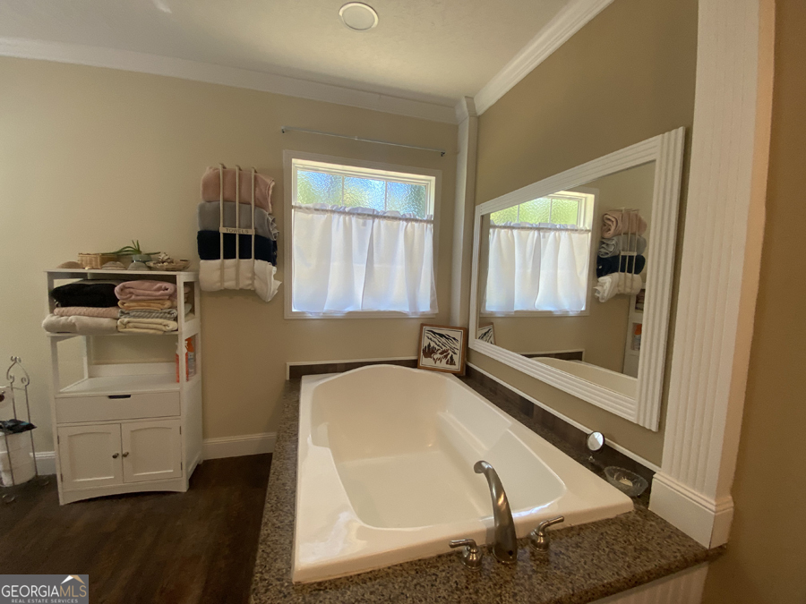 347 River Trail Martin, GA 30557 - Photo 15 of 29 a bathroom with a tub sink and mirror