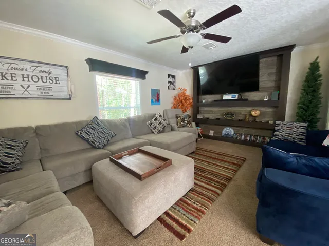 a living room with furniture and a flat screen tv