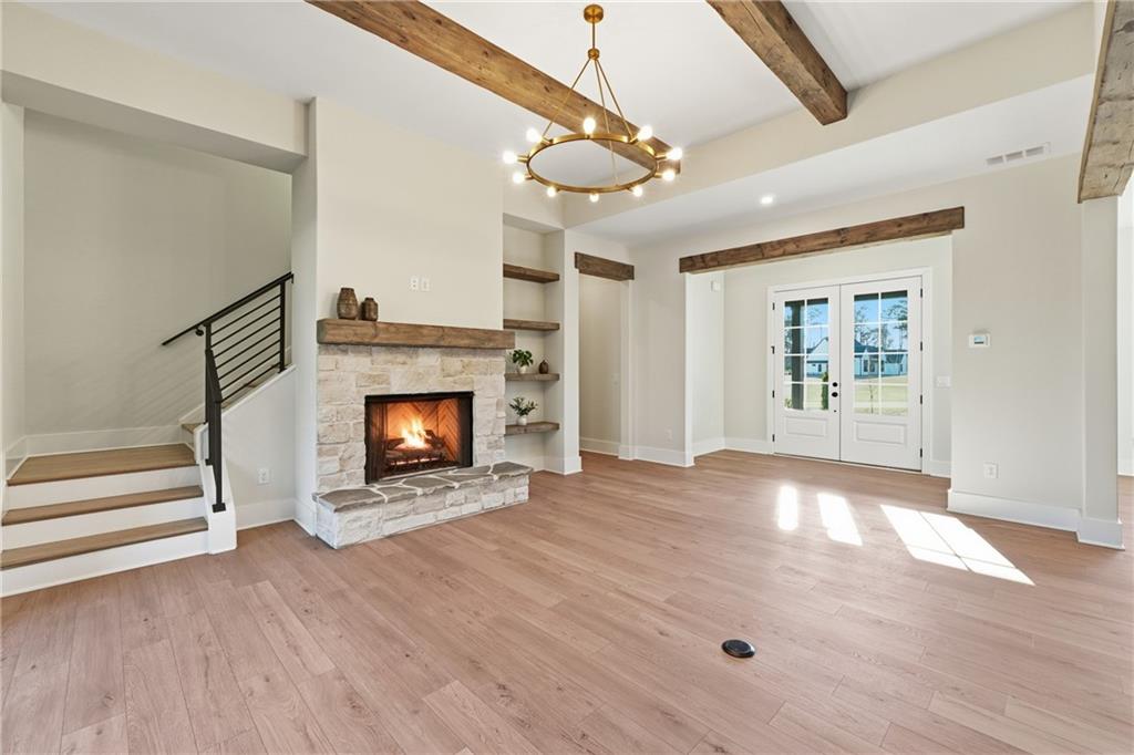 157 Palisade Drive Rydal, GA 30171 - Photo 21 of 68 a view of an empty room with wooden floor fireplace and a window