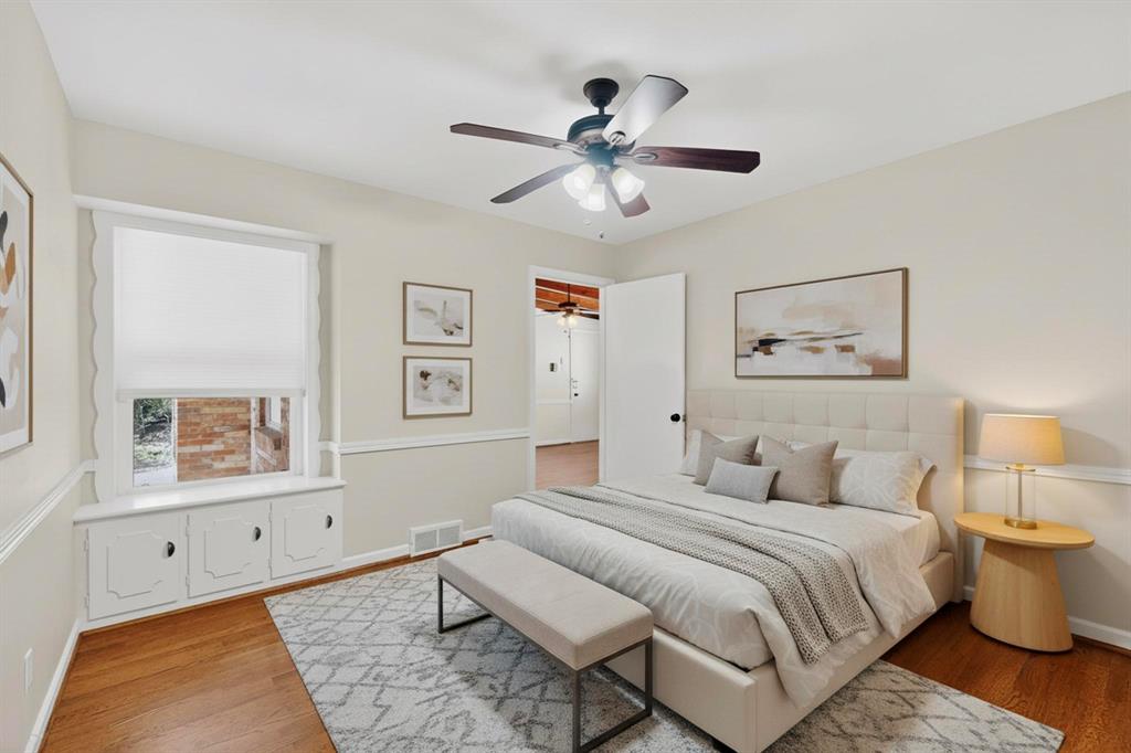 2120 Healey Drive Dallas, TX 75228 - Photo 32 of 39 a spacious bedroom with a bed and a chandelier
