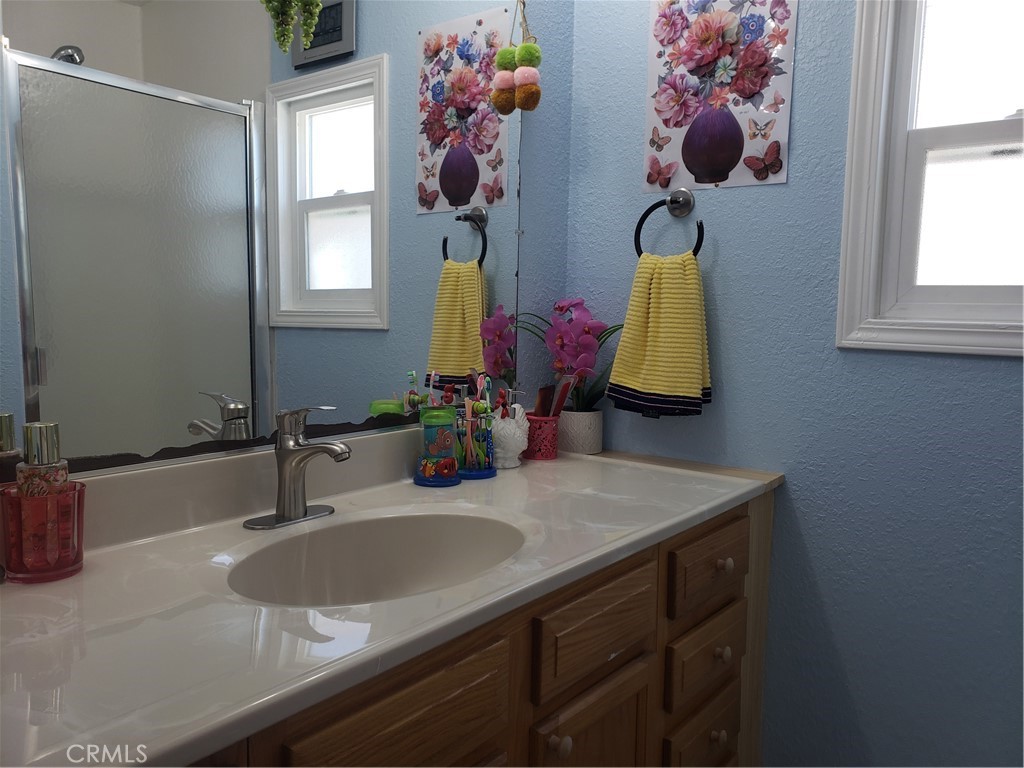 3929 West 5th Street, Unit 16 Santa Ana, CA 92703 - Photo 11 of 21 a bathroom with a sink and a mirror