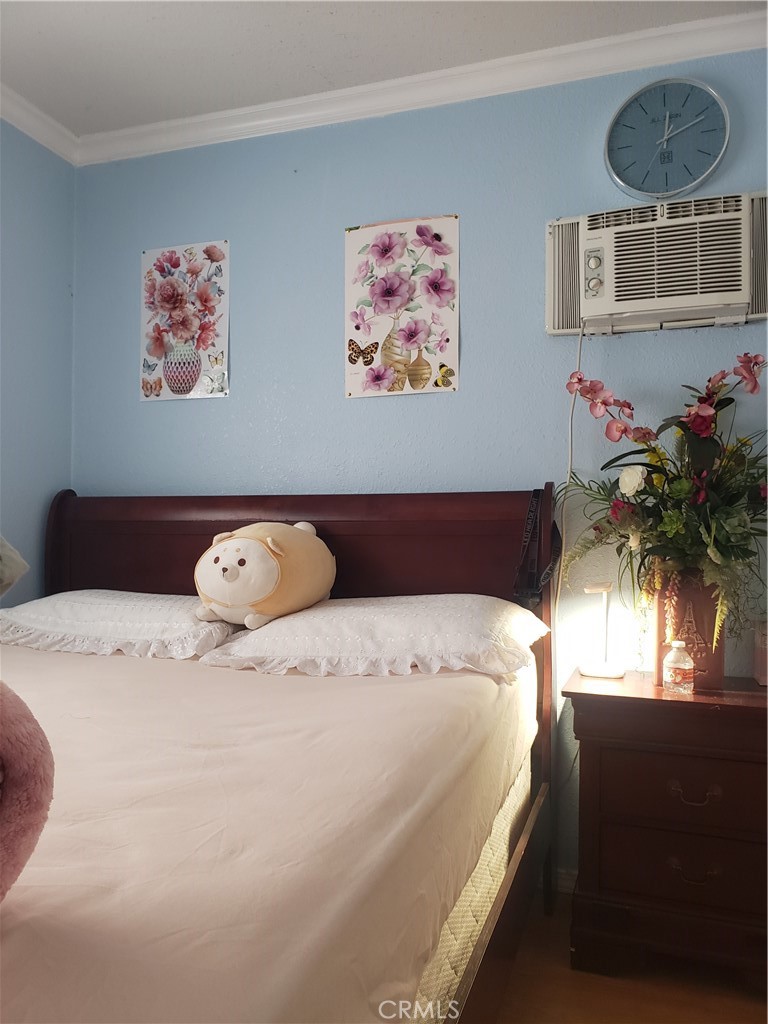 3929 West 5th Street, Unit 16 Santa Ana, CA 92703 - Photo 13 of 21 a bed with a bed and a painting on the wall