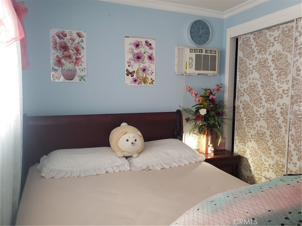 3929 West 5th Street, Unit 16 Santa Ana, CA 92703 - Photo 14 of 21 a bedroom with a bed and a painting on the wall