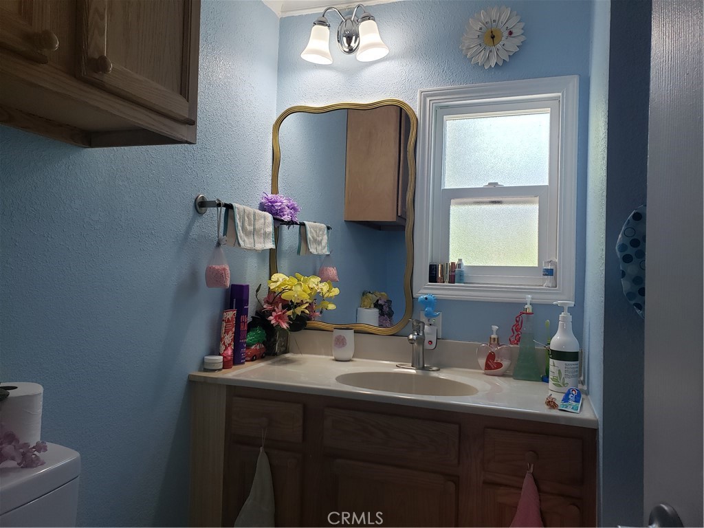 3929 West 5th Street, Unit 16 Santa Ana, CA 92703 - Photo 16 of 21 a bathroom with a sink vanity and a mirror