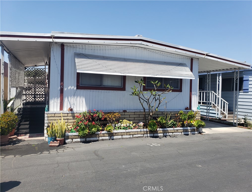 3929 West 5th Street, Unit 16 Santa Ana, CA 92703 - Photo 2 of 21 front view of house with outdoor seating