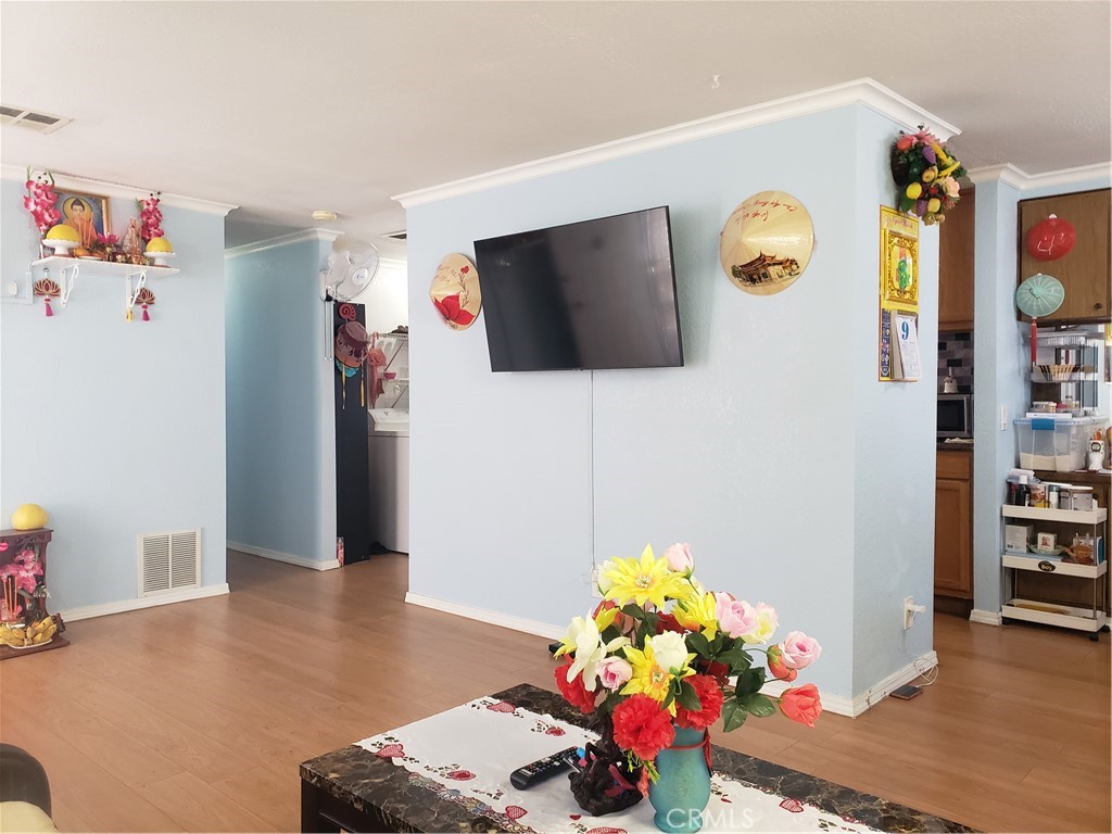 3929 West 5th Street, Unit 16 Santa Ana, CA 92703 - Photo 6 of 21 a living room with furniture and a flat screen tv