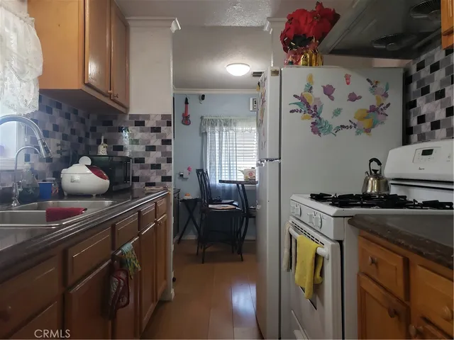 a kitchen with stainless steel appliances granite countertop a sink and cabinets