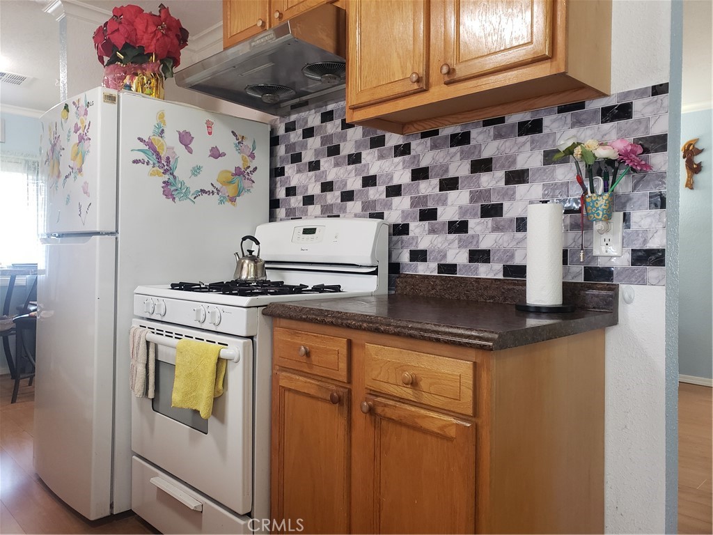 3929 West 5th Street, Unit 16 Santa Ana, CA 92703 - Photo 8 of 21 a kitchen with stainless steel appliances granite countertop a sink and cabinets