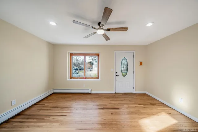 wooden floor in an empty room with a window