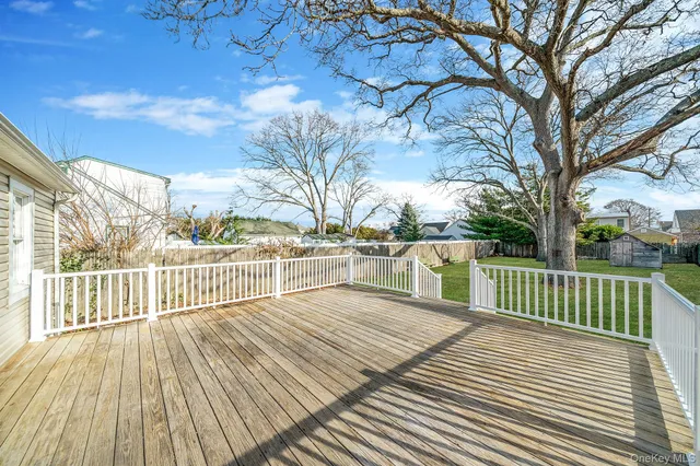 a view of a patio with wooden floor and fence