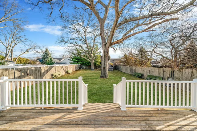 a view of a house with a wooden fence