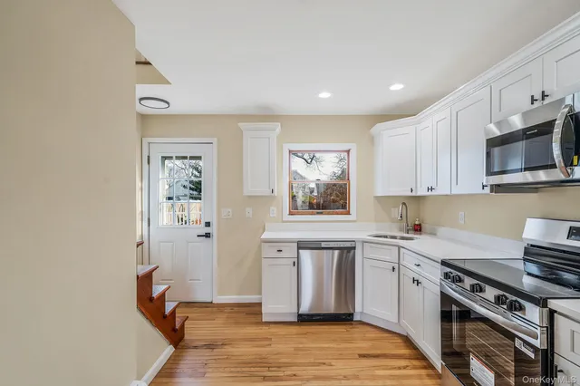 a kitchen with stainless steel appliances a sink stove and cabinets