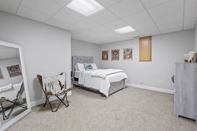 a bed room with a bed and a chair