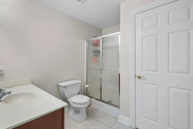a white toilet sitting next to a bathroom sink
