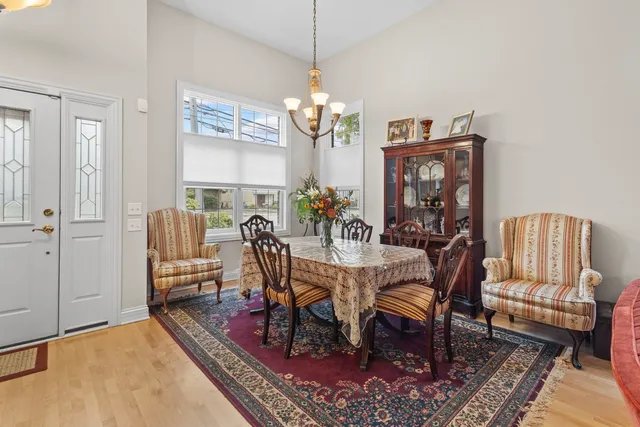 a view of a dining room with furniture a rug and wooden floor
