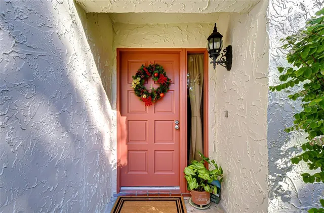 a vase with flowers sitting on a brick wall