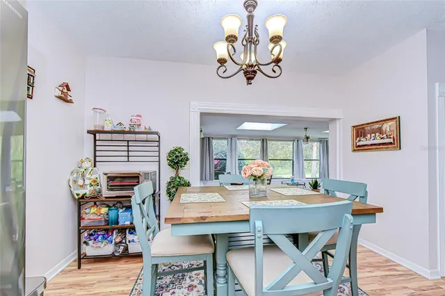 a view of a dining room with furniture wooden floor and a chandelier