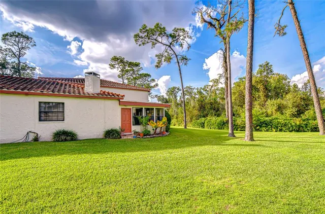 a view of a house with a yard and garage