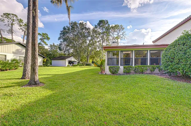 a view of a house with yard and tree s