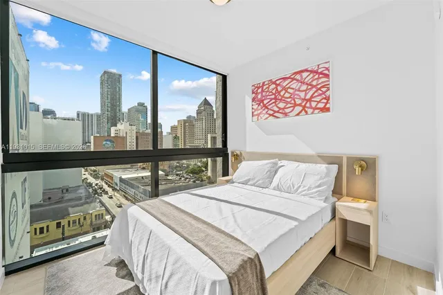 a bed sitting in a bedroom next to a large window