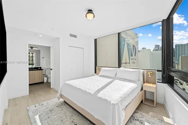 a living room with a bed furniture and a flat tv screen