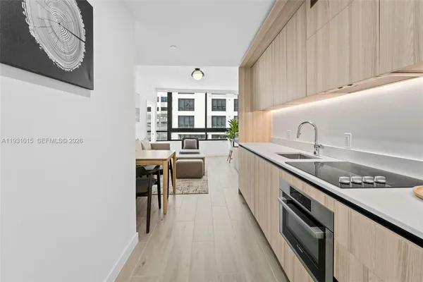 a kitchen with stainless steel appliances a sink a stove and cabinets