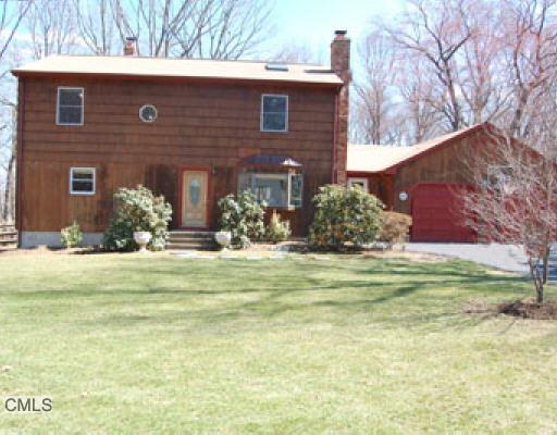 283 Putting Green Road Fairfield, CT 06825 - Photo 1 of 1 a front view of house with outdoor space and trees around