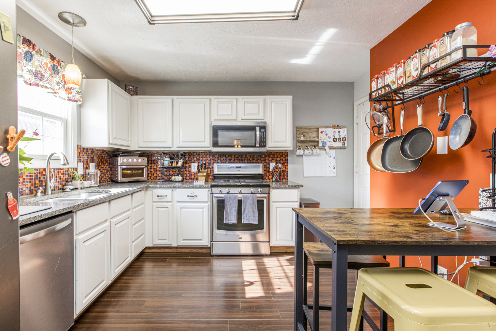 1111 Chippewa Street Normal, IL 61761 - Photo 12 of 35 a kitchen with stainless steel appliances granite countertop a stove top oven a sink dishwasher and cabinets with wooden floor