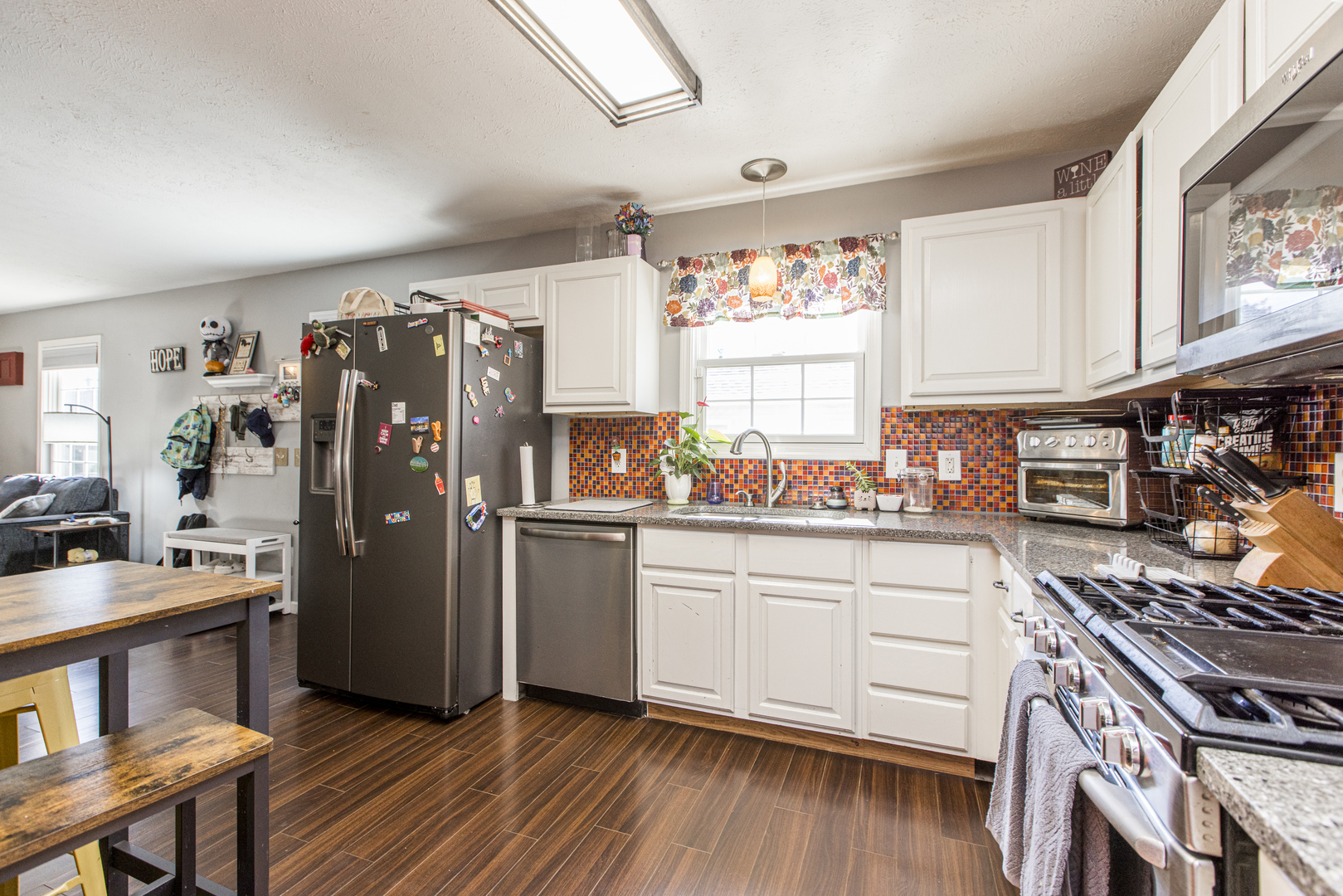 1111 Chippewa Street Normal, IL 61761 - Photo 13 of 35 a kitchen with stainless steel appliances granite countertop a hardwood floor sink stove and refrigerator