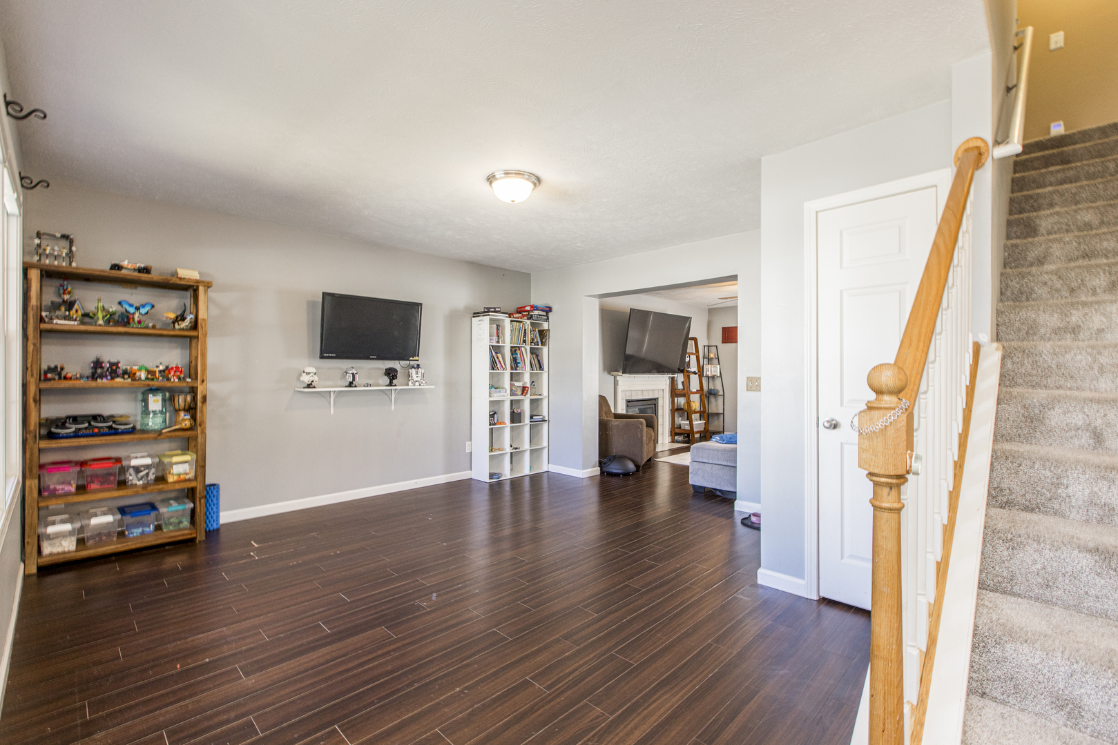 1111 Chippewa Street Normal, IL 61761 - Photo 7 of 35 a view of a livingroom with wooden floor and a flat screen tv