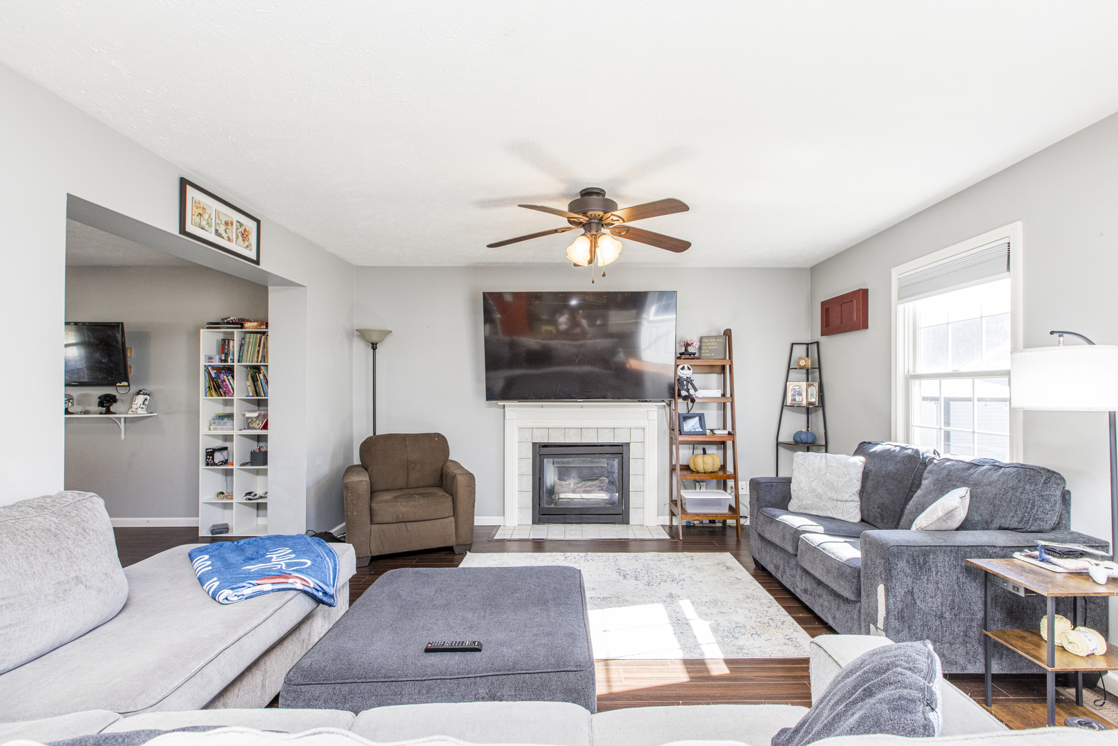 1111 Chippewa Street Normal, IL 61761 - Photo 10 of 35 a living room with furniture a flat screen tv and a fireplace