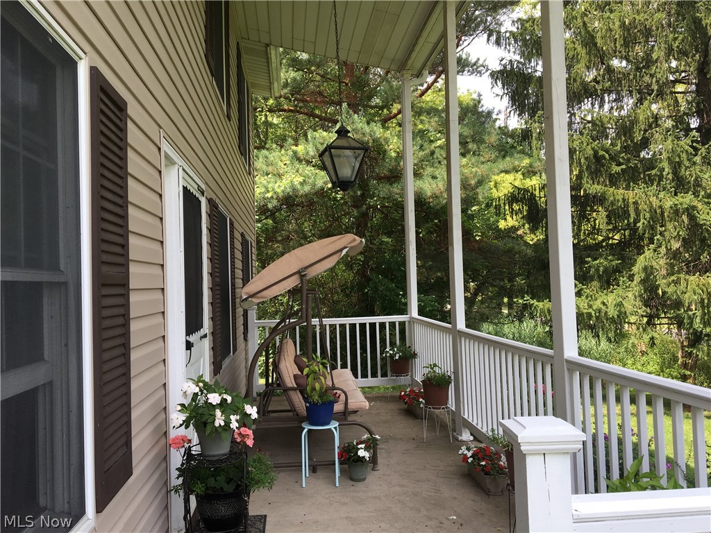 Welcoming front porch with clean lines and tall pillars