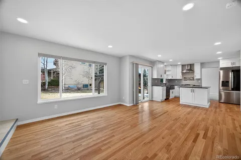 a view of an empty room with window and fire place