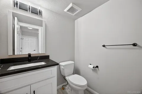 an empty room with a ceiling fan and window