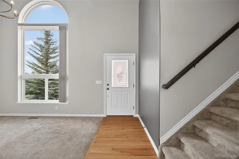 a view of a livingroom with wooden floor and entryway