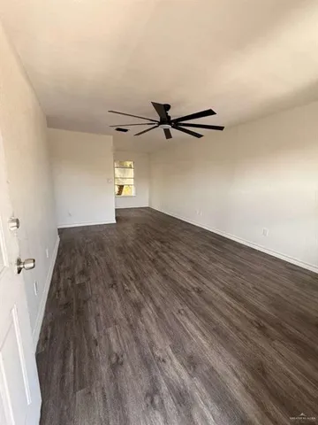 a view of a room with wooden floor
