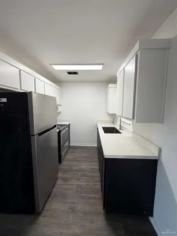 a kitchen with stainless steel appliances a refrigerator and a sink