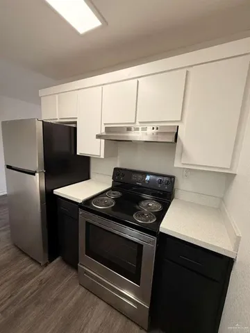 a kitchen with a stove and a refrigerator