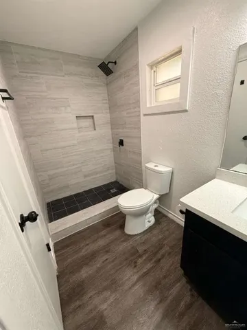 a bathroom with a toilet and a shower