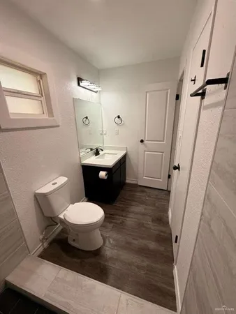a bathroom with a toilet sink and mirror